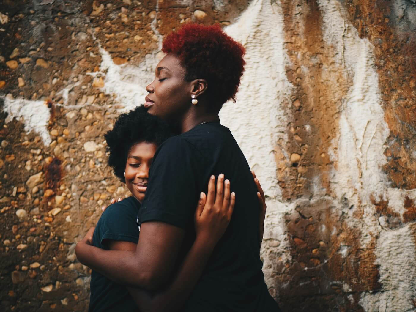 Girl and mom hugging each other